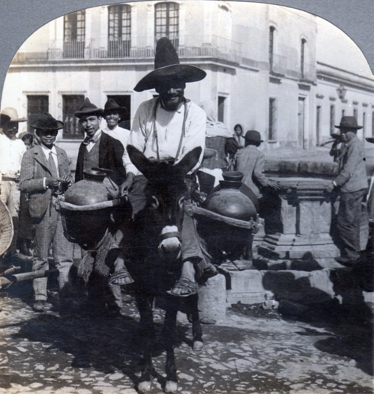 Aguador, luego de haber llenado sus jarros en una fuente